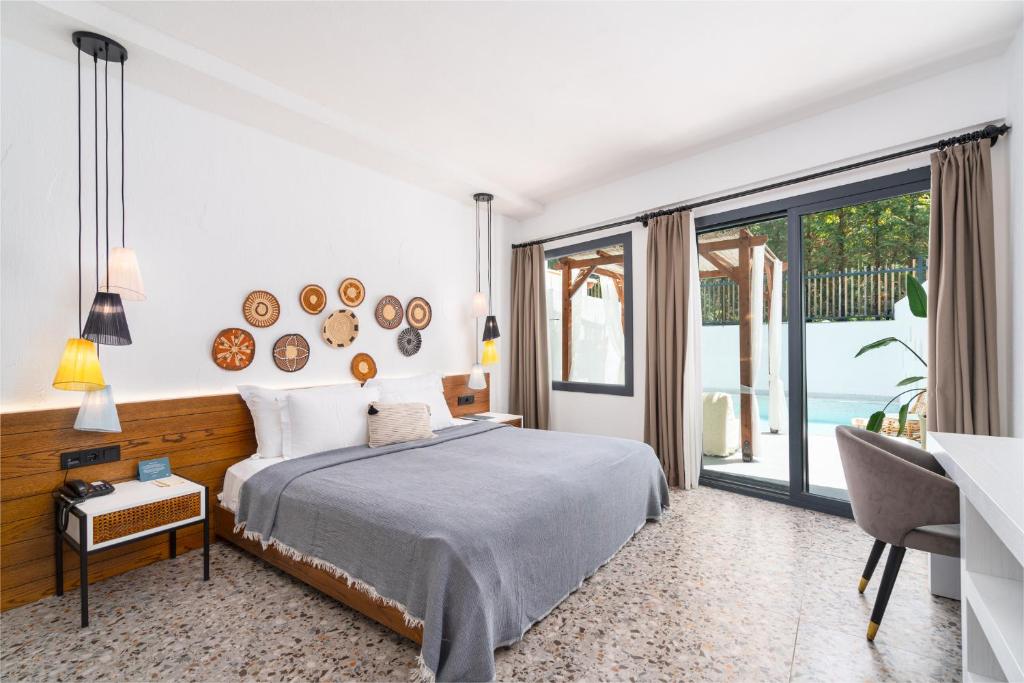 a bedroom with a bed and a view of the ocean at Ölüdeniz Blu Luxury Unique Hotel - Adults-Only in Oludeniz