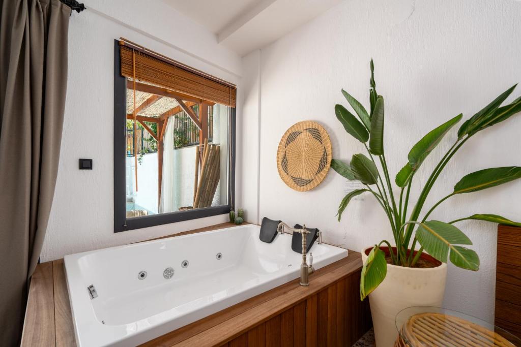 a bathroom with a sink and a potted plant at Ölüdeniz Blu Luxury Unique Hotel - Adults-Only in Oludeniz