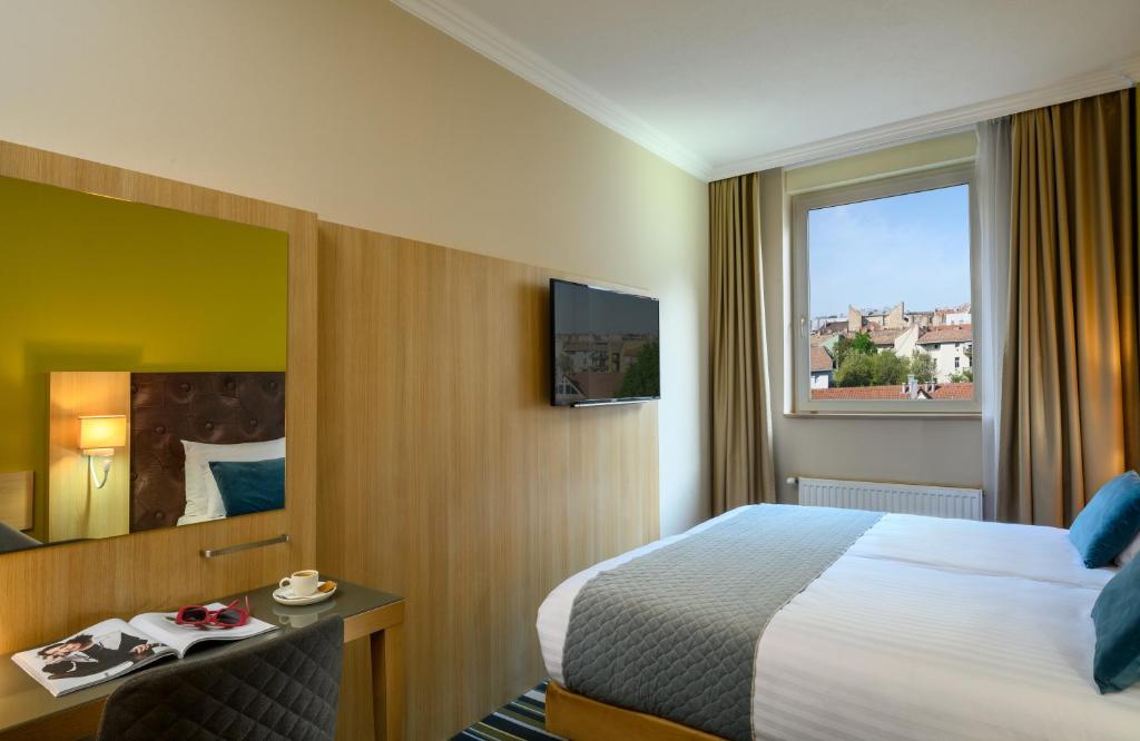 Postel nebo postele na pokoji v ubytování Leonardo Hotel Budapest