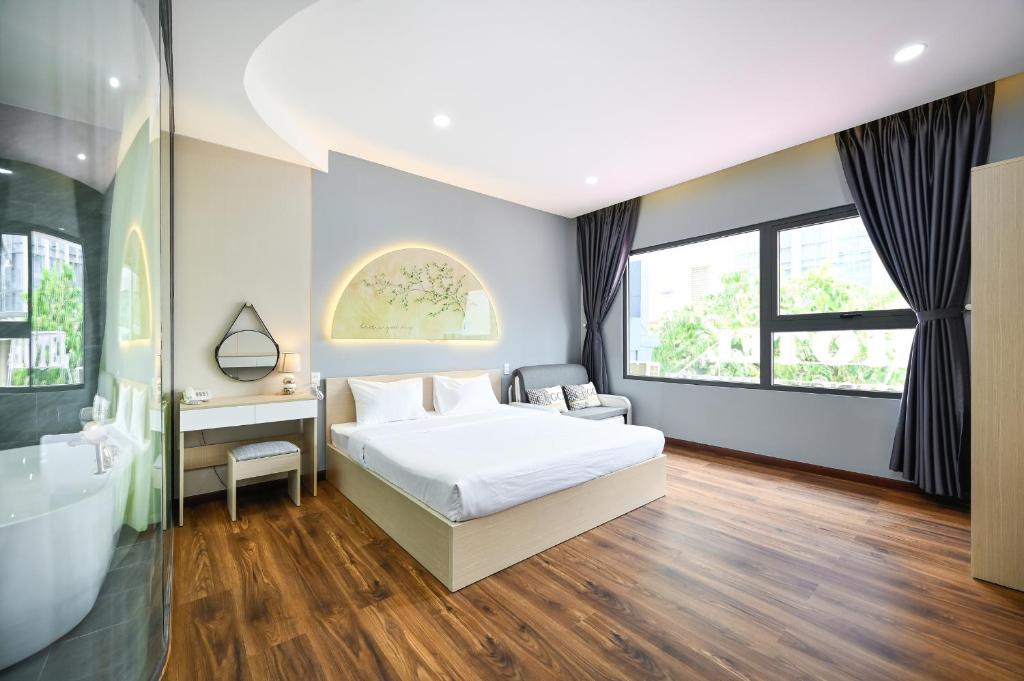 a bedroom with a bed and a sink and a tub at Sunrise Airport Hotel in Ho Chi Minh City
