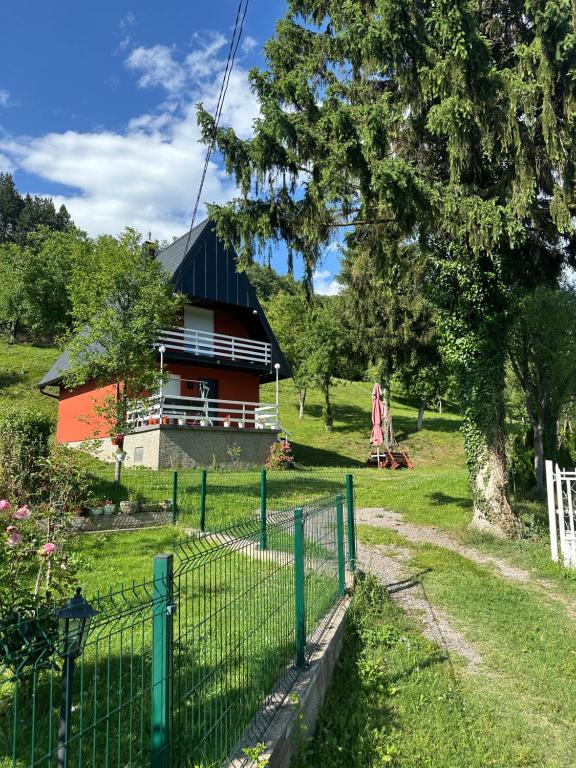 a fence in front of a house at Weekend getaway house in Goražde
