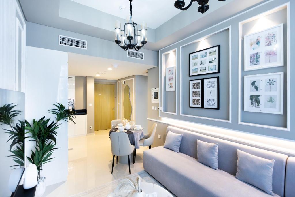 a living room with a couch and a table at Cozy 1 BR apartment in Dubai near Burj khalifa in Dubai