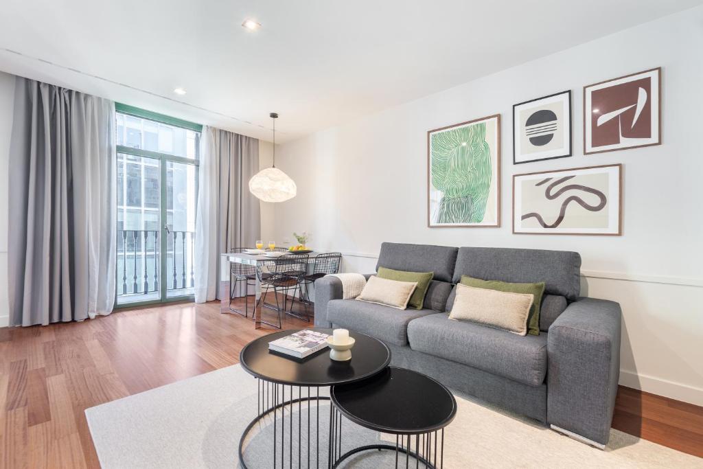 a living room with a couch and a table at Aspasios Paseo de Gracia Apartments in Barcelona
