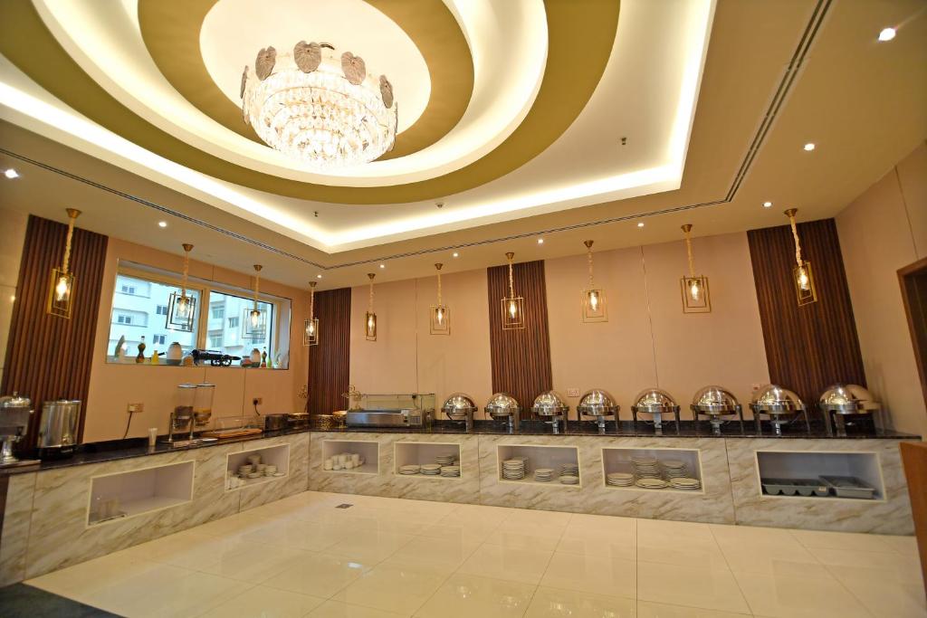 a large room with a chandelier and a dance floor at Nejoum Al Emarat in Sharjah