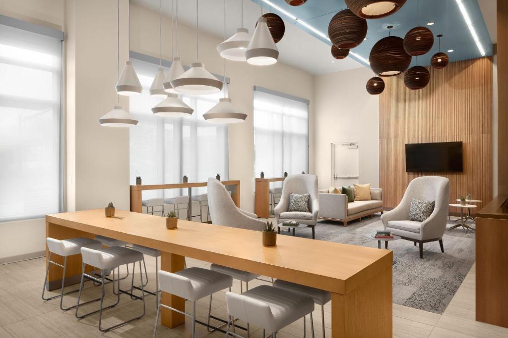 a conference room with a wooden table and chairs at Element by Marriott Charlotte Uptown in Charlotte