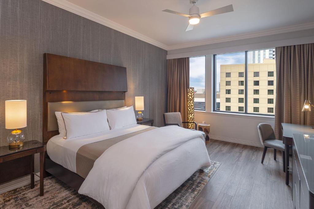 a hotel room with a bed and a large window at The Westin Houston Downtown in Houston