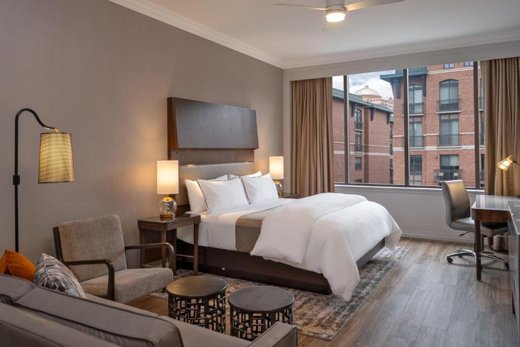 a hotel room with a bed and a living room at The Westin Houston Downtown in Houston