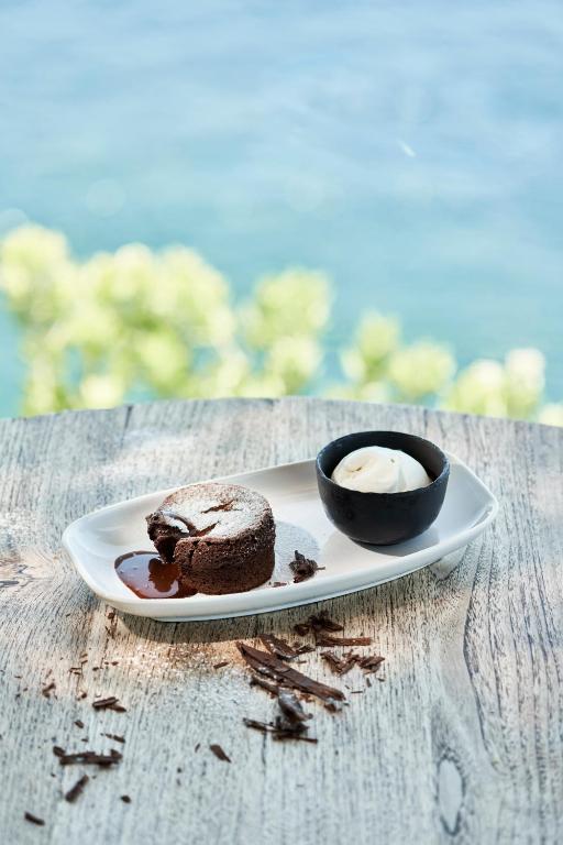 a plate with a chocolate cake and a cup of coffee at Les Suites at The Cliff Bay - PortoBay in Funchal