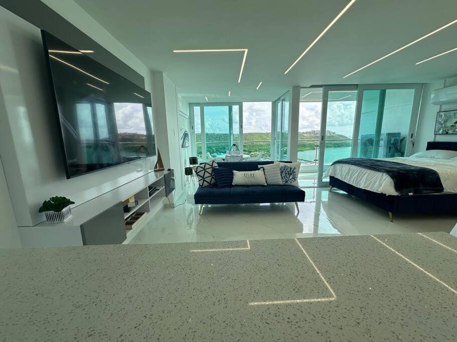 a large bedroom with a bed and a tv at Brisa Del Mar in Fajardo