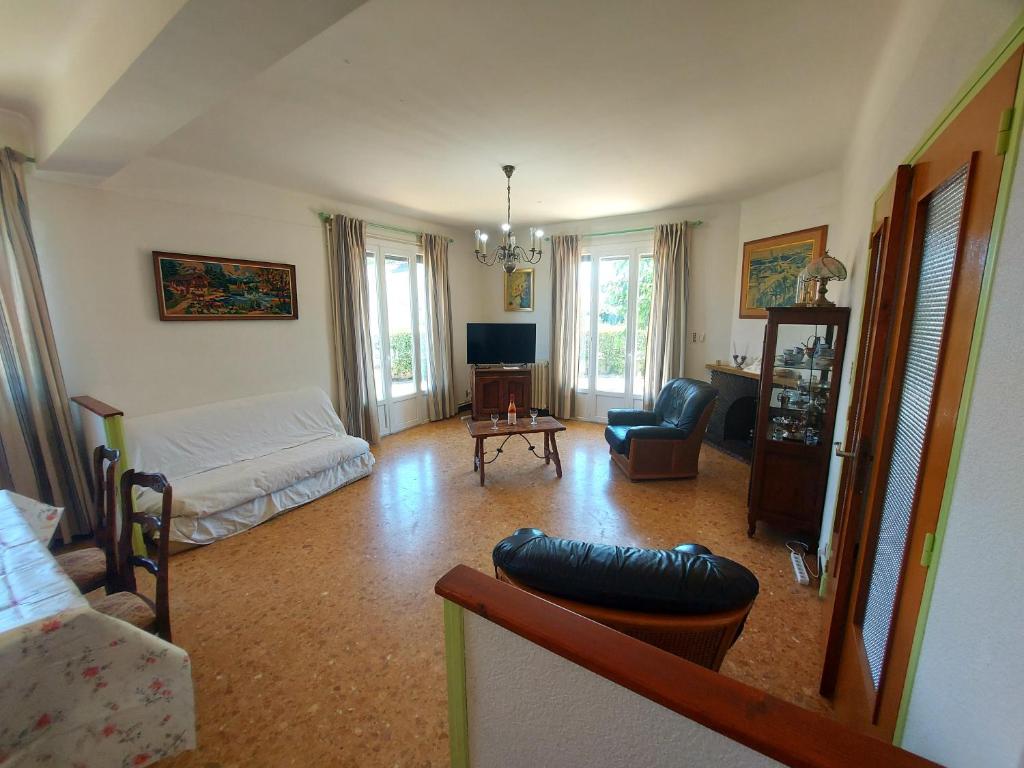 un salon avec un canapé et une table dans l'établissement 120m2 rdc 2km mer soleil catalan 2ch wifi 4pers ok chéques vacances animaux, à Latour-Bas-Elne