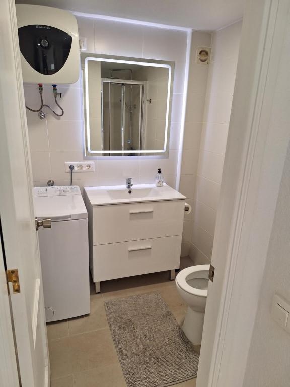a bathroom with a sink and a toilet and a mirror at EL CARDENAL Casa Lise Playa del Cura in Playa del Cura