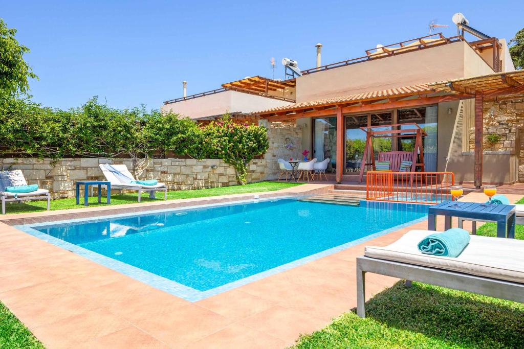 una piscina en el patio trasero de una casa en Villa Portokalia Platanias, en Plataniás