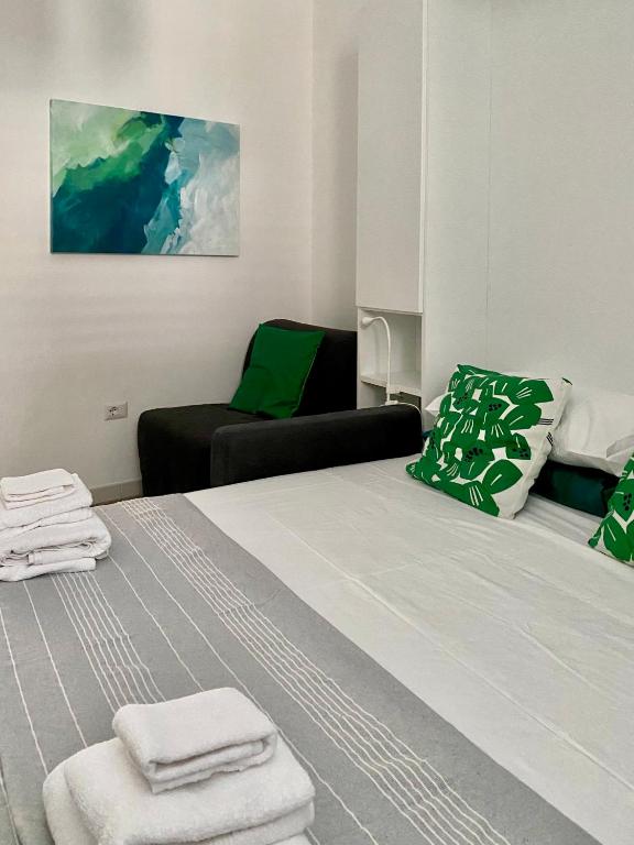 a hotel room with a bed and a chair at Casa Vita Scilla in Scilla