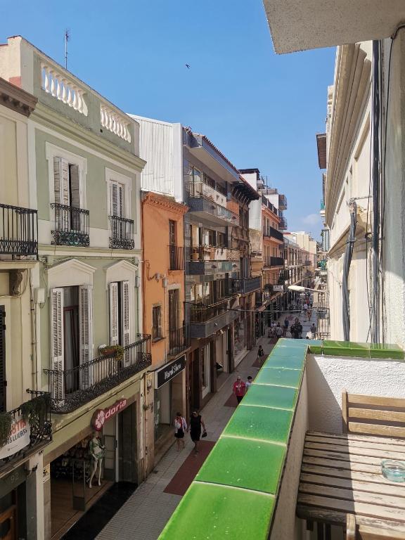 a view from a balcony of a street with buildings at Apartamento centrico en Calella in Calella