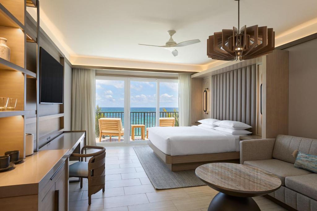 a hotel room with a bed and a view of the ocean at JW Marriott St Maarten Beach Resort & Spa in Dawn Beach