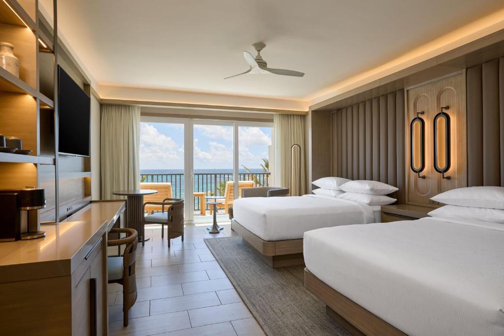 a hotel room with two beds and a balcony at JW Marriott St Maarten Beach Resort & Spa in Dawn Beach