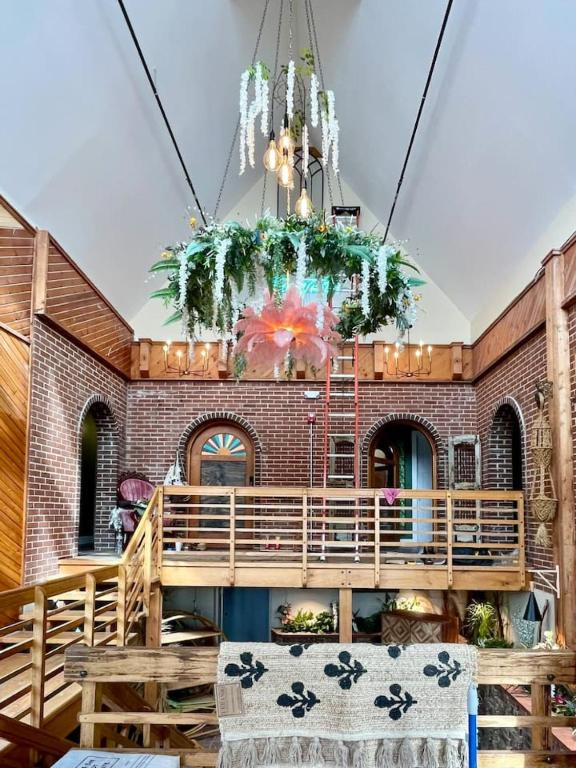 a chandelier in a room with a brick wall at The Atrium - A Boutique Hotel - Suite 17 in Perryville