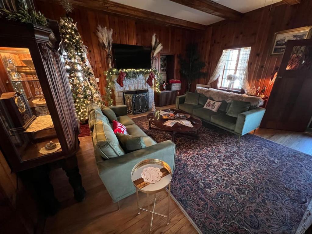 a living room filled with furniture and a christmas tree at The Mediterranean House - Beautiful Downtown House in Perryville