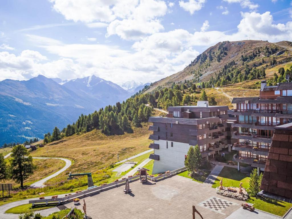 an aerial view of a building with mountains in the background at Studio Greppon 107 by Interhome in Les Collons