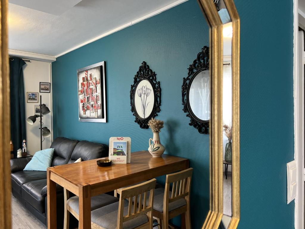 - un salon avec une table et un miroir dans l'établissement Le Solena, à Calais