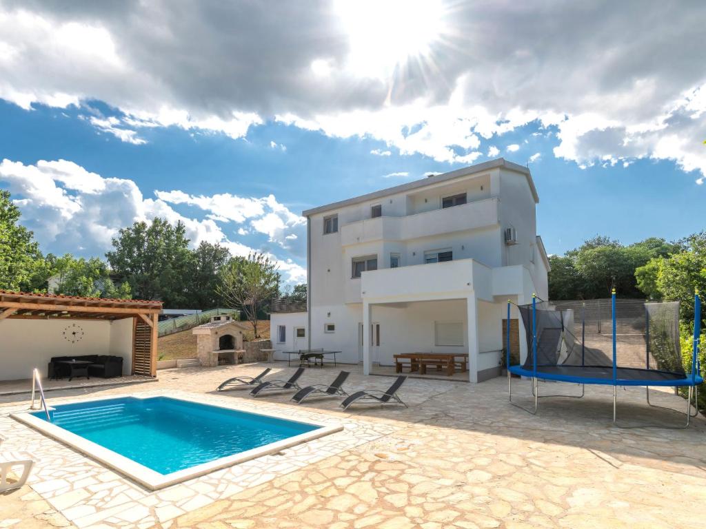 a villa with a swimming pool and a house at Holiday Home Villa Dalmatina by Interhome in Imotski