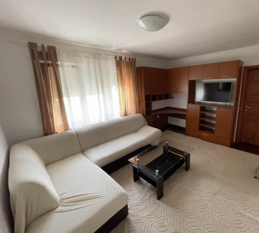 a living room with a couch and a coffee table at Lorena Apartment in Šibenik