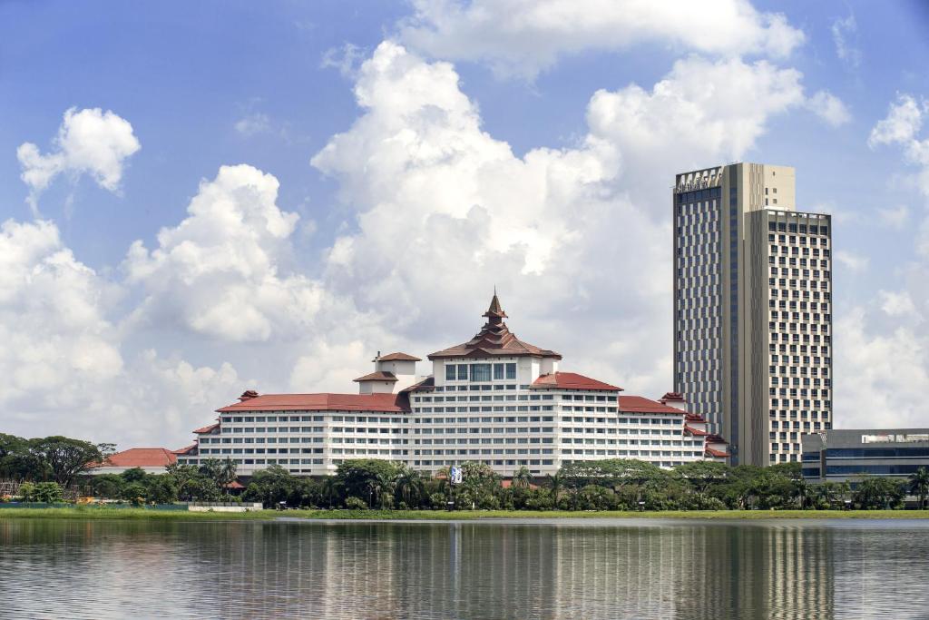 a large building with two tall buildings next to a body of water at Sedona Hotel Yangon in Yangon