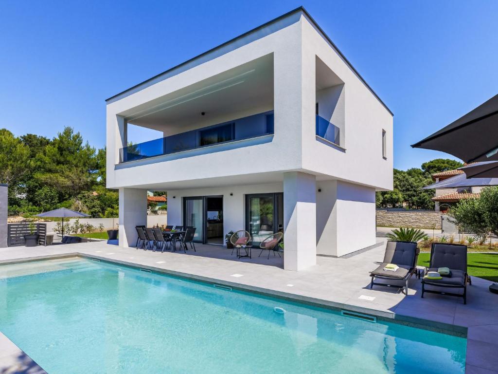 a modern villa with a swimming pool and a house at Villa David by Interhome in Medulin