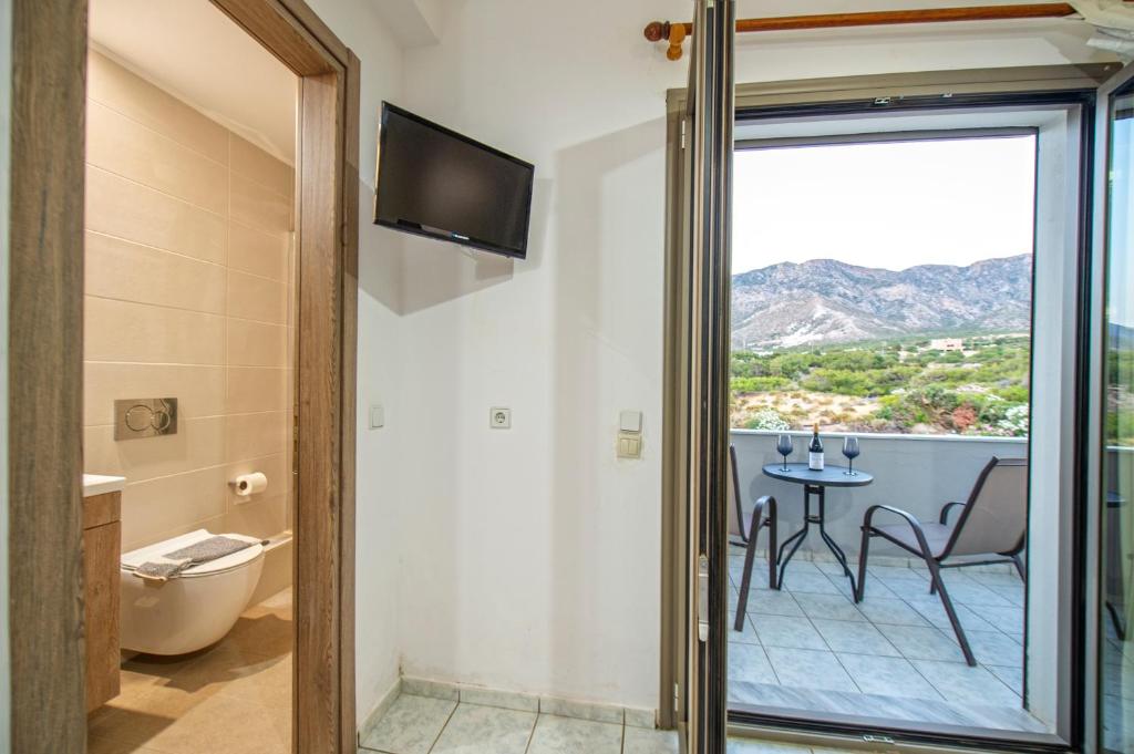 a room with a balcony with a table and chairs at Panorama in Elafonisi