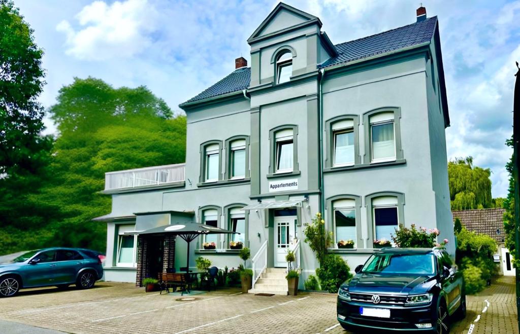 a blue house with a car parked in front of it at Haus Medaillon in Hamm