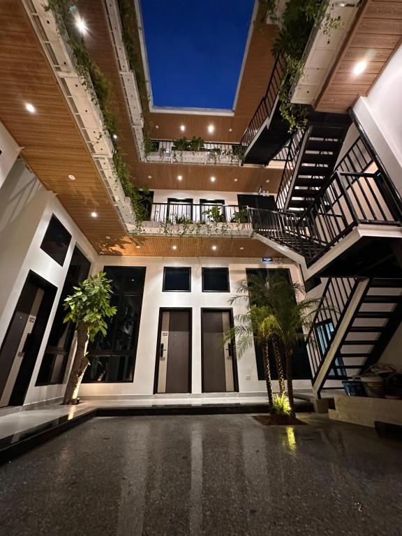 a large building with stairs and a courtyard at The Eudora Homestay in An Khê