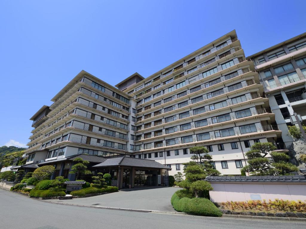 a large apartment building with a courtyard at Inatori Ginsuiso in Higashiizu