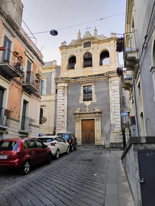 a building with cars parked in front of it at Nicaredda in Catania