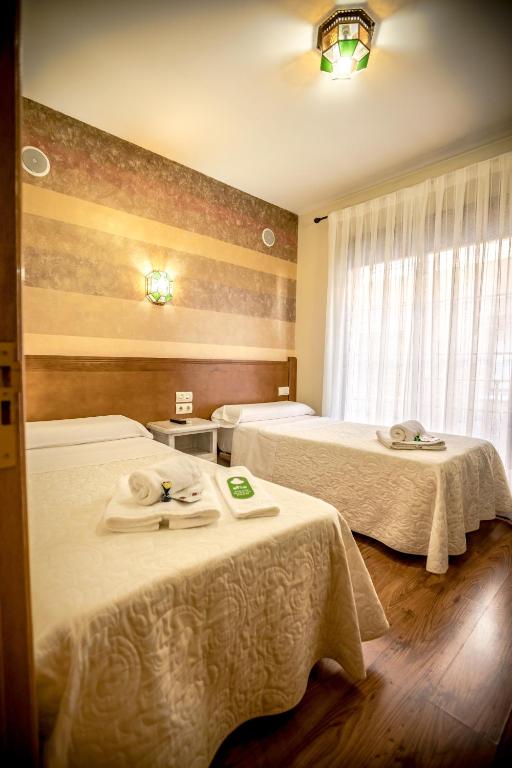 Postel nebo postele na pokoji v ubytování Hostal Tic-Tac