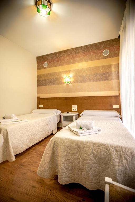 Postel nebo postele na pokoji v ubytování Hostal Tic-Tac