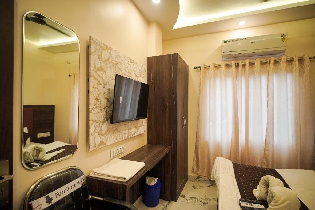 TV a/nebo společenská místnost v ubytování HOTEL VIA GANGA INN ! గంగా ఇన్ ద్వారా హోటల్ VARANASI! FULLY AIR-CONDITIONED HOTEL AT PRIME LOCATION WITH ROOFTOP GANGES VIEW! 2 Min walking distance from ASSI GHAT ,NEAR KASHI VISHWANATH TEMPLE