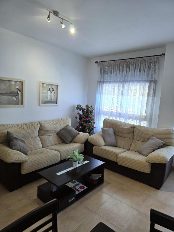 a living room with a couch and a christmas tree at Maestrat13 in Peñíscola
