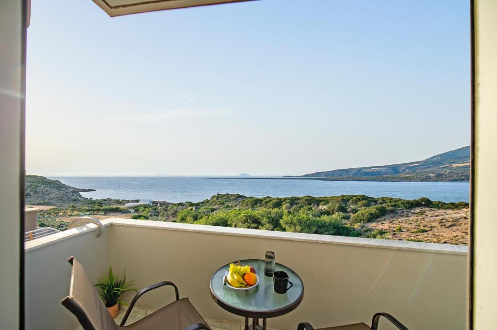 a table on a balcony with a view of the water at Panorama in Elafonisi