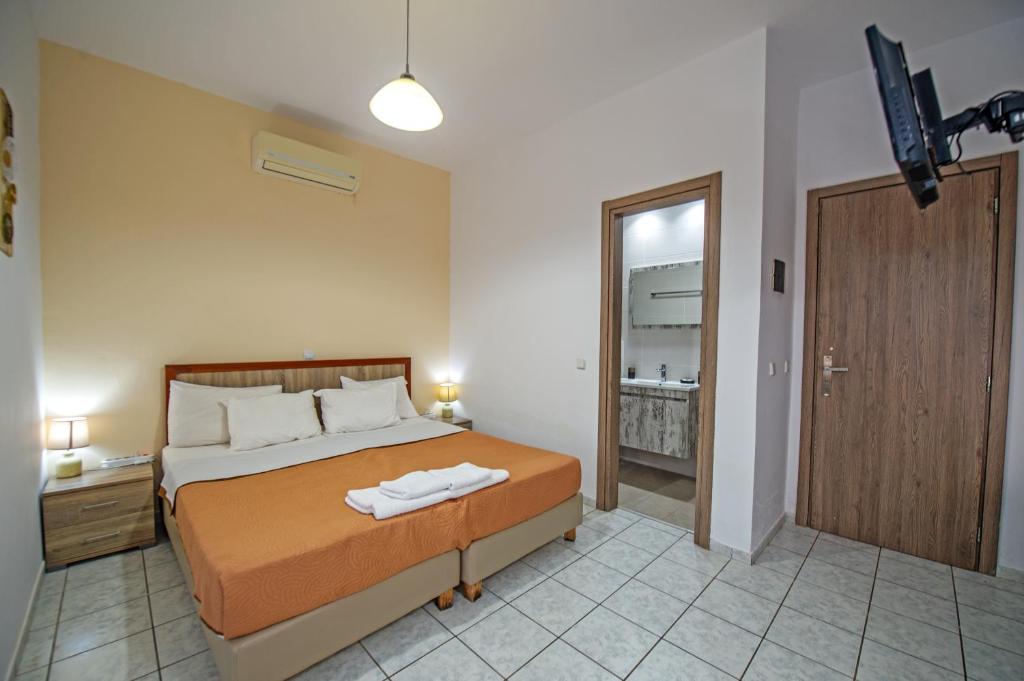 a bedroom with a bed with a robe on it at Panorama in Elafonisi