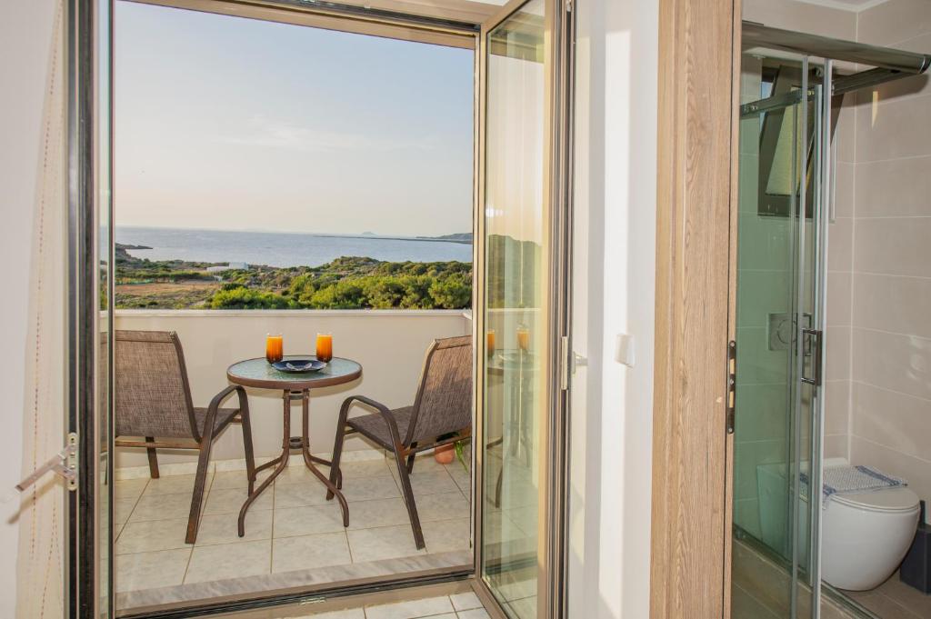 a room with a balcony with a table and chairs at Panorama in Elafonisi