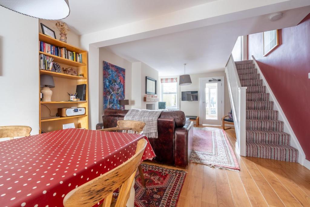 a living room with a table and a couch at Chic 2-bedroom townhouse in vibrant Abergavenny in Abergavenny