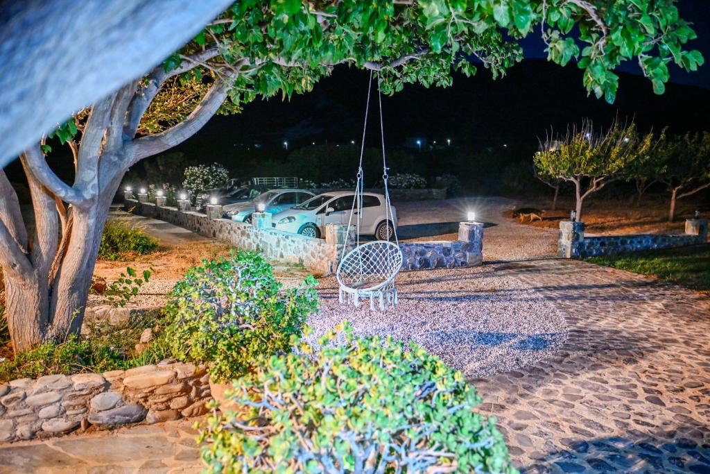 a swing with a car parked in a yard at night at Panorama in Elafonisi