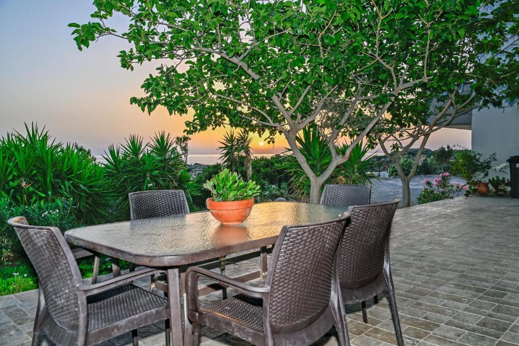a wooden table and chairs on a patio at Panorama in Elafonisi