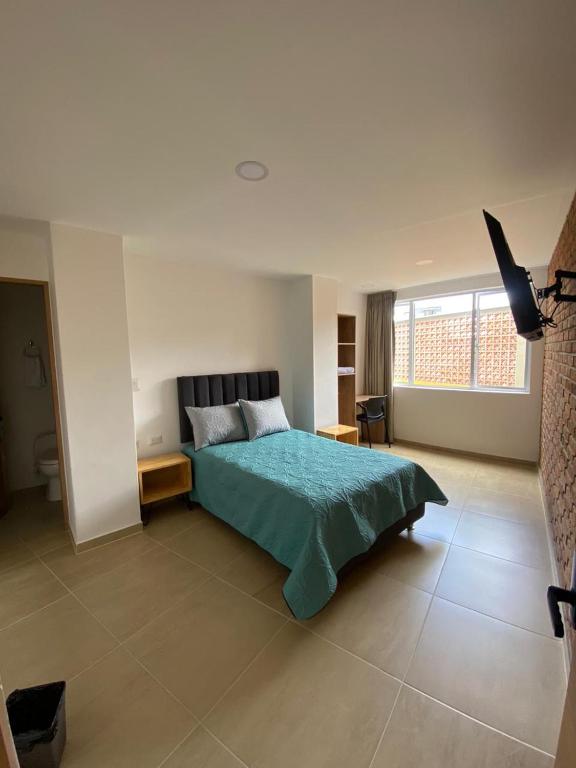 Postel nebo postele na pokoji v ubytování BISÁU Hotel