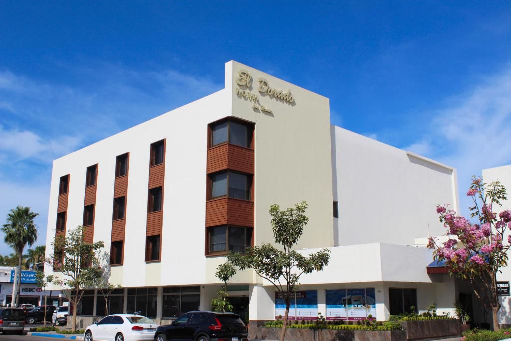 a white building with a sign on it at El Dorado in Los Mochis