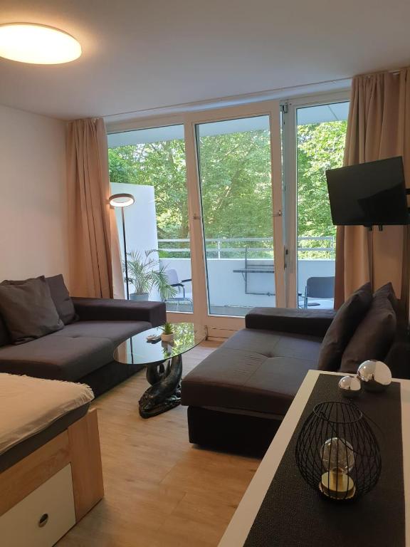 a living room with a couch and a table at Bonn Lounge in Bonn
