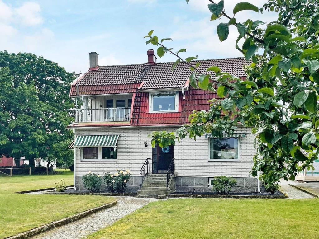 a house with a red roof and a yard at 4 star holiday home in SÖLVESBORG in Sölvesborg