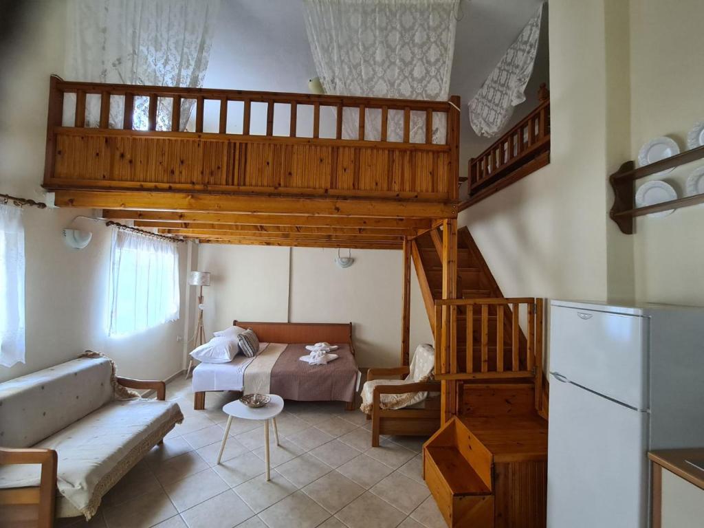 a living room with a loft bed and a couch at ANATOLIS loft houses 2 in Mola Kalyva