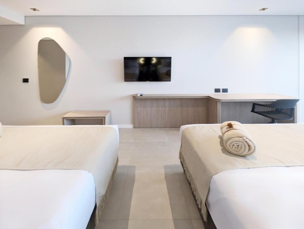 Postel nebo postele na pokoji v ubytování Botanico Hotel y Spa