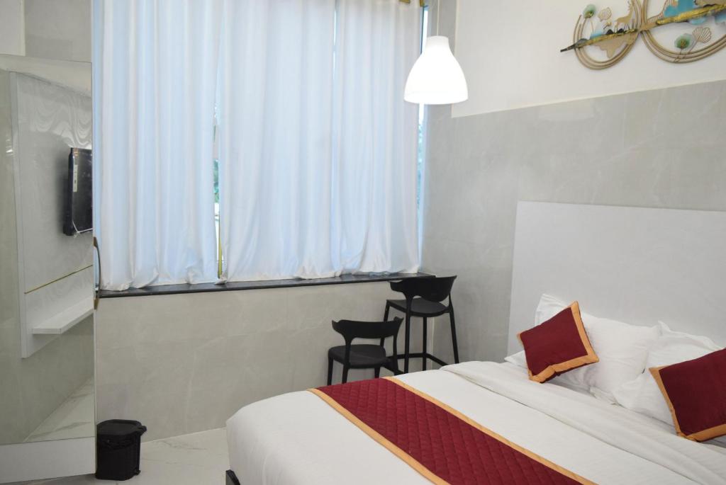 Postel nebo postele na pokoji v ubytování M Grand Stay